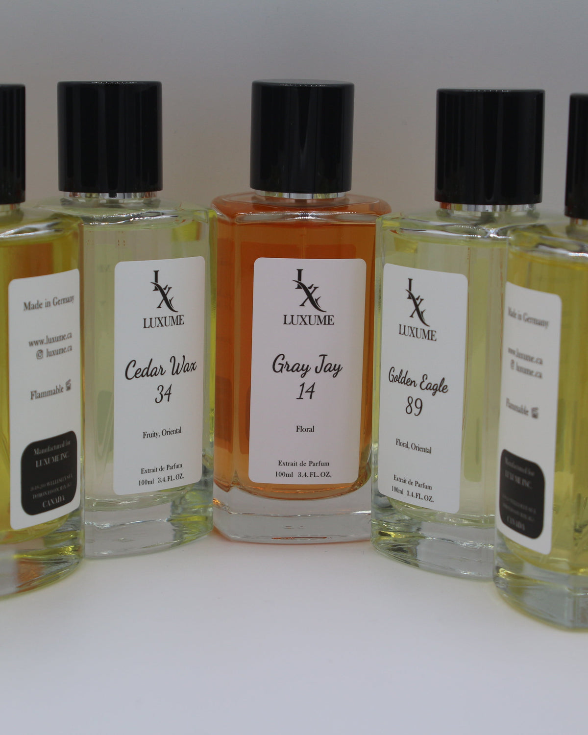 Collection of small bottles with labels on a white background